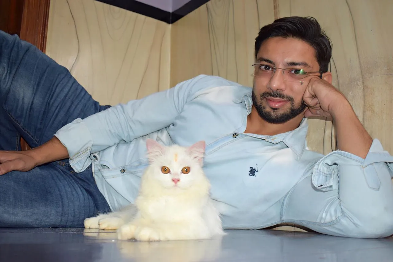 Owner resting at home next to a white Persian cat